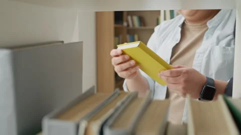 Asian Student Selecting Book from Bookshelf in University Library Stock Footage 337474280
