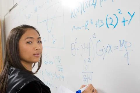 Asian Student Solving Problem On White Board Stock Photos