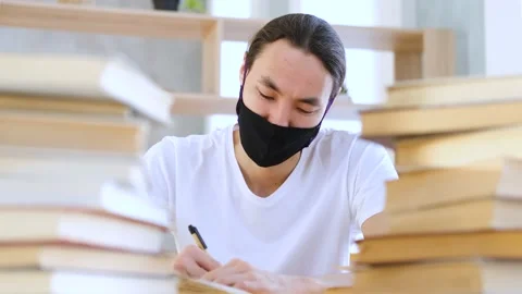 Asian student study among piles of books Stock Footage 151833603