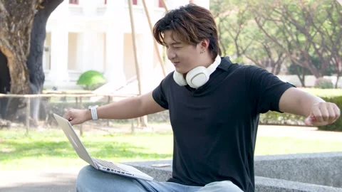 Asian Student Using Laptop and Stretching on University Campus Outdoors Stock Footage 335192585