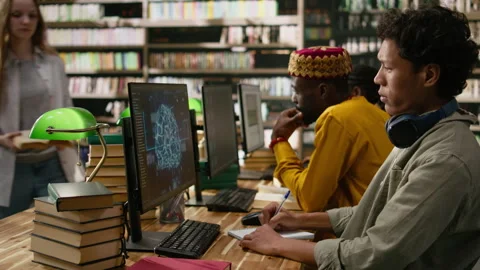 Asian student working with AI brain display on desktop monitor in library Stock Footage 337229092
