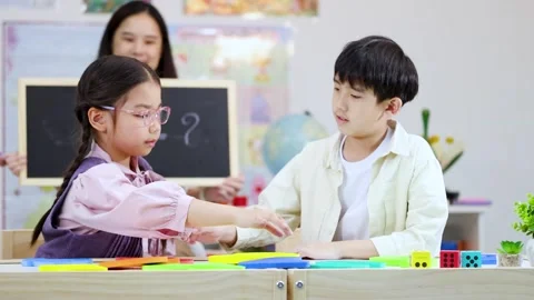 Asian Students and Teacher Learning Math with Letter Blocks in Classroom Stock Footage 326748132