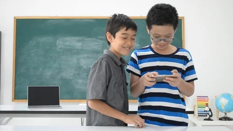 Asian students boy using laptop learning in the classroom at school Stockbeeldmateriaal 105148741