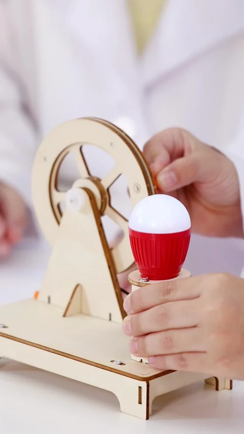 Asian Students Conducting Electricity Experiment with Wooden Generator Model Stock Footage 340254028