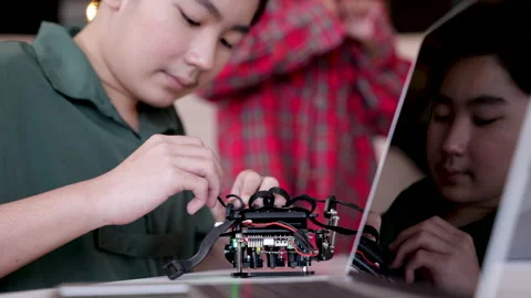 Asian students focus to fix the robot machine, groups of multiethnic colleg.. Stock Footage 246722409