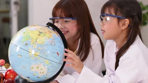 Asian Students in Lab Coats Studying World Globe in Science Class Stock Footage 341667750