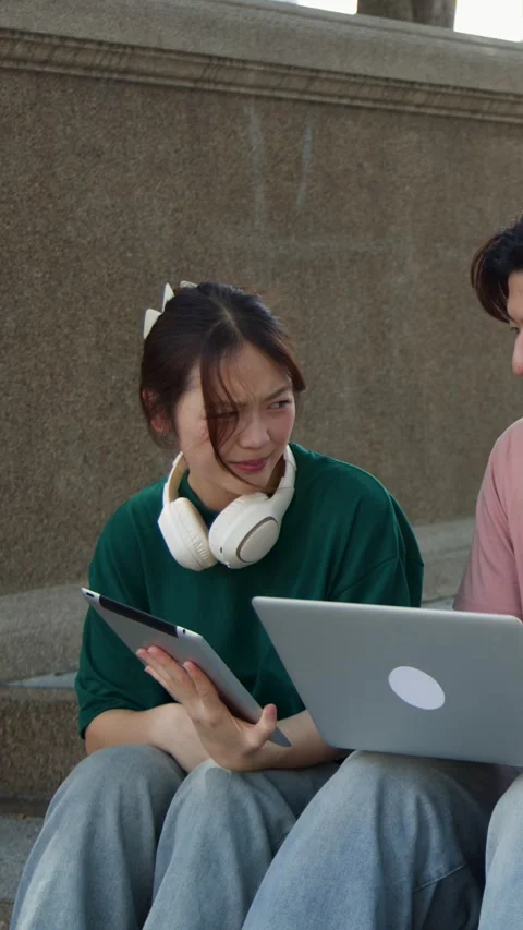 Asian Students Studying Together with Laptop and Tablet on Campus Stairs Stock Footage 341465909