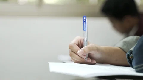 Asian students taking an exam Stock Footage 119697105
