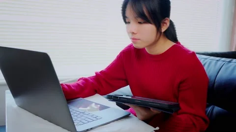 Asian students work from home on tablet devices to do information research, make Stock Footage 146457577
