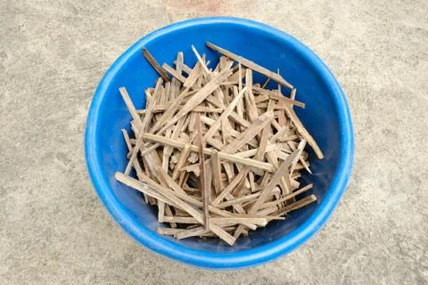 Asian styled pile of tiny firewood chopped in the blue bucket Stock Photos