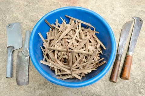 Asian styled tiny firewood in the blue bucket with various styles knives Stock Photos