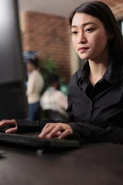 Asian system administrator upgrading firewall system in order to maintain Stock Photos