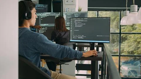 Asian system engineer working with html script on computer screen Foto stock