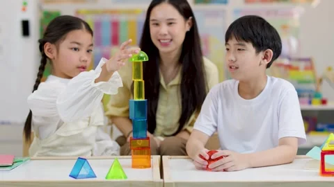 Asian Teacher and Primary Students Learning Geometry with Colorful 3D Shapes Stock Footage 326083735