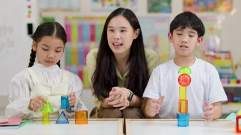 Asian Teacher and Students Learning Geometry with Colorful 3D Shapes Stock Footage 325838948