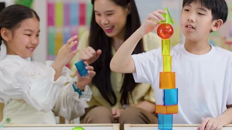 Asian Teacher and Students Learning Geometry with Colorful 3D Shapes Stock Footage 326083786