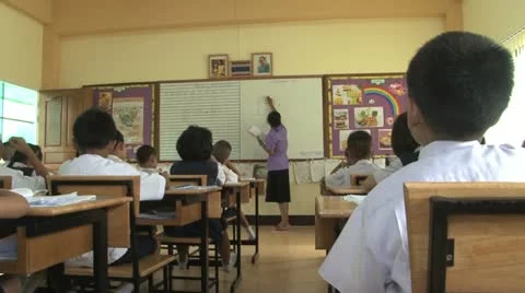 Asian Teacher Explains Lesson In The Classroom 스톡 동영상 12437048