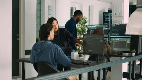 Asian team of artificial intelligence cloud programers talking about programming Stock Photos