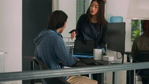 Asian team of IT engineers analyzing html code on terminal window Stock Footage 227613341