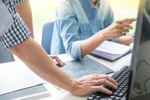 Asian team Outsource Developer Looking Screen Programming Code Working with L 写真素材