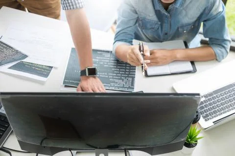 Asian team Outsource Developer Looking Screen Programming Code Working with L Stock Photos