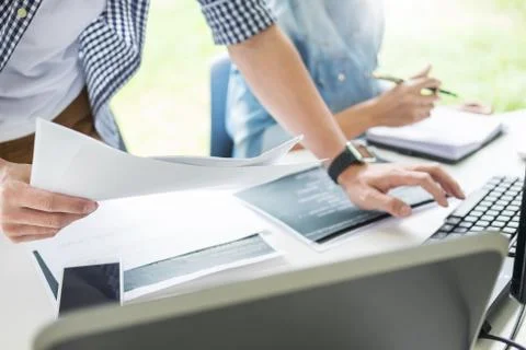 Asian team Outsource Developer Looking Screen Programming Code Working with L 写真素材