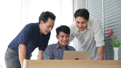 Asian team workers using laptop computer discuss at office Stock Footage 159325554