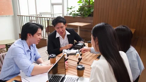 Asian Tech Startup Team Discussing Robot Dog and VR Project Stock Footage 346018409