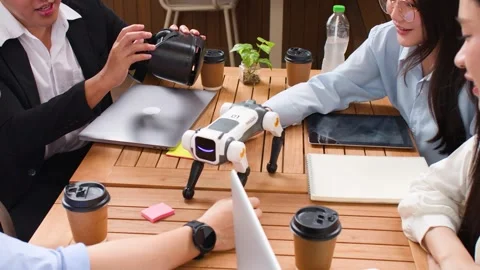 Asian Tech Team Testing Robot Dog and VR Headset Outdoors Stock Footage 346018425