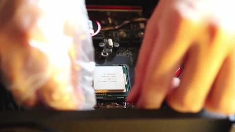 Asian technician installing high end Intel core i5 CPU into the socket  Stock-Footage 158735851