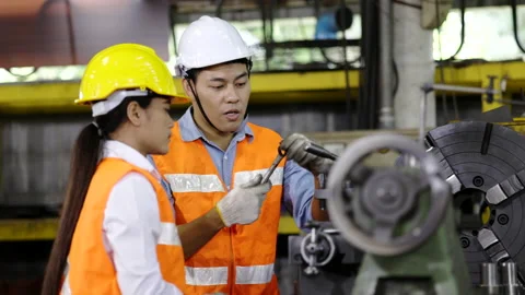 Asian technician or engineer working on machine in industrial plant. Stock Footage 154259918