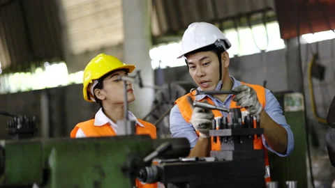 Asian technician or engineer working on machine in industrial plant. Stock Footage 154259941