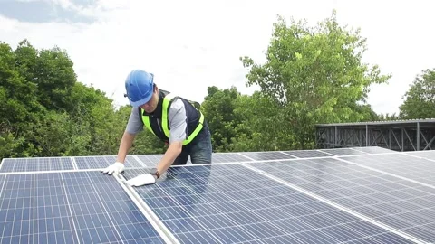 Asian technicians wearing blue helmets Installing solar panels Stock Footage 147417784