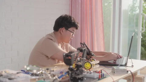 Asian teen coding robotic car at home, STEM education and home learning Stock Footage 307389529