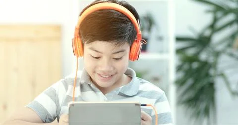 Asian teens playing tablet computer with smile face . Stock Photos