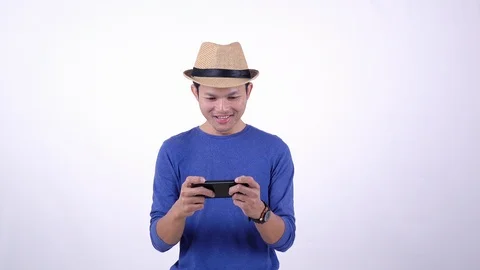Asian Thai tourist using smart phone for play game on line on white background Stock Footage 119053271