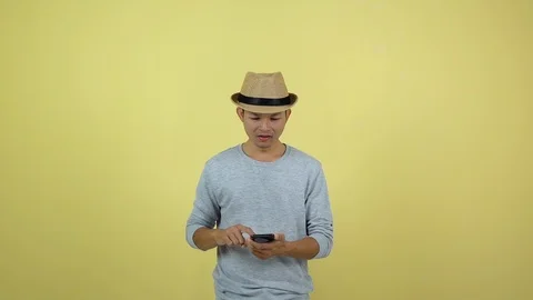 Asian Thai using smart phone for shopping on line on yellow background Stock Footage 120898244