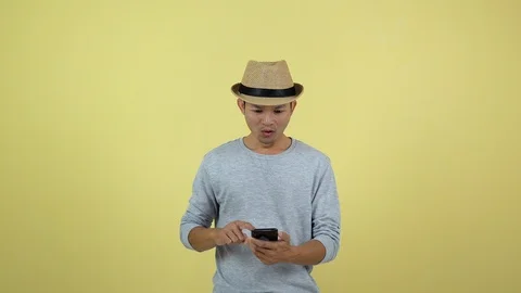 Asian Thai using smart phone for shopping on line on yellow background Stock Footage 120899700