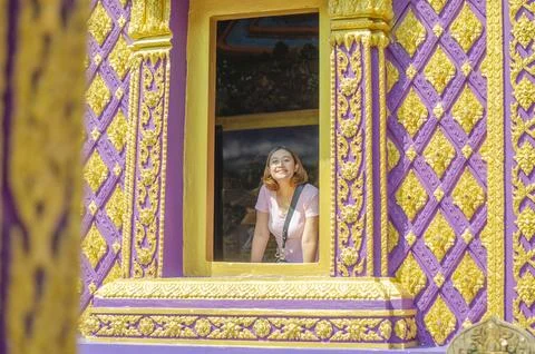 Asian Thai woman takes photo with purple church at Bang Chak Temple Stock Photos