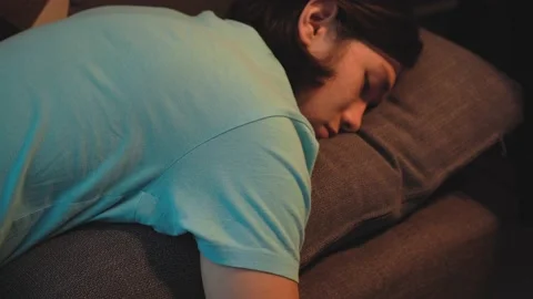 Asian Tired  Man Is Sleeping at Couch Face in the Pillow Stock Footage 148347652