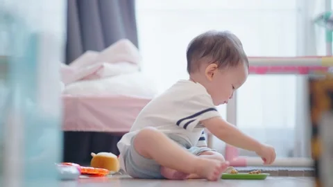 Asian toddler boy sit down on the floor playing with toys. Stock Footage 279505871