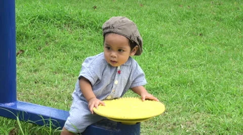 Asian Toddler Climbs On Exercise Equipment At The Park Stock-Footage 36814101