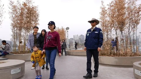 Asian torists walking at spring park, Seoul, South Stock Footage 104804665
