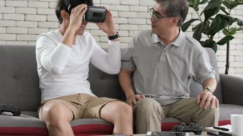Asian two age generations men family old father playing video games Video stock 139694805