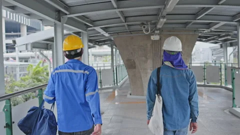 Asian Two construction workers wearing uniform And hard hat Traveling to work Stock Footage 144330492