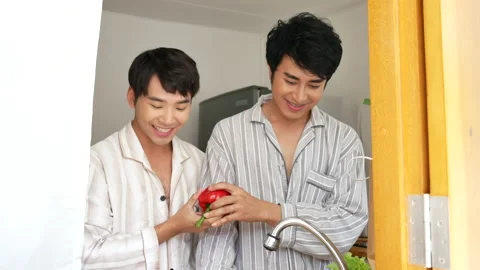 Asian two Man hands wash cleaning fresh vegetable in kitchen. Happy Asian gay co Video stock 205535279