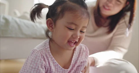 Asian Two Year Old little Girl Watching Tablet on Floor enjoyment Video stock 336644475