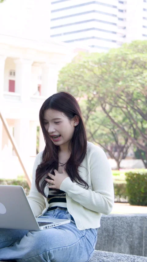 Asian University Student Having a Video Call on Laptop at Campus Stock Footage 337600534