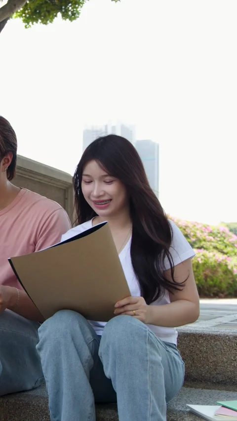 Asian University Students Studying Together on Campus Steps Outdoors Stock Footage 345715515