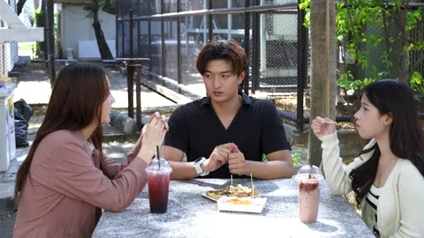 Asian University Students Talking and Eating at Outdoor Cafeteria Table Stock Footage 329010789